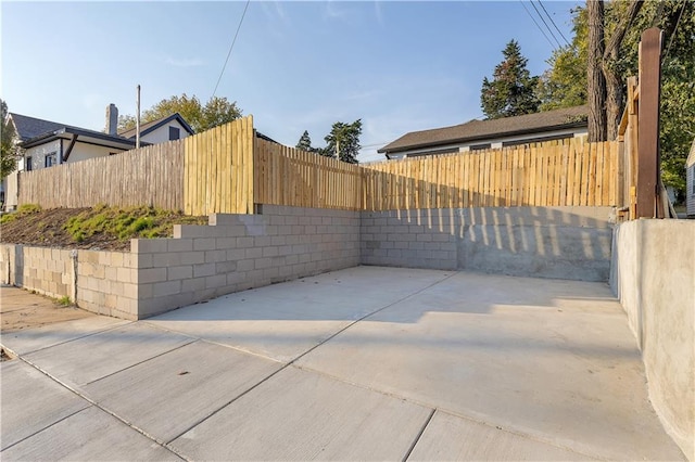 view of gate featuring a patio area