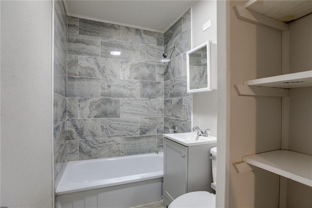 full bathroom with tiled shower / bath, vanity, and toilet