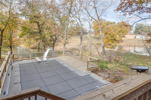 view of swimming pool featuring a water view