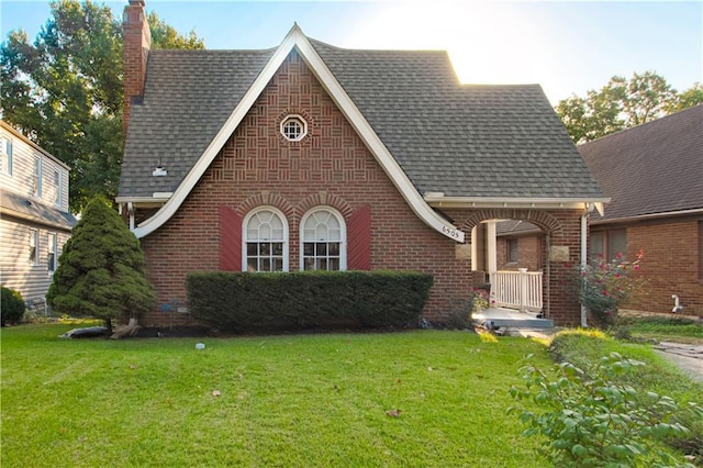 english style home with a front yard