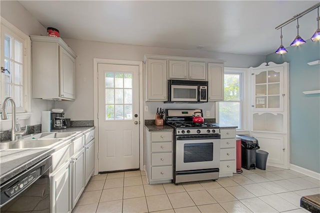 kitchen featuring dishwasher, plenty of natural light, white gas stove, and white cabinetry