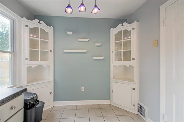 unfurnished dining area featuring light tile patterned floors