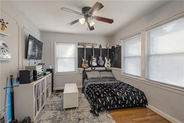 bedroom with ceiling fan and hardwood / wood-style floors