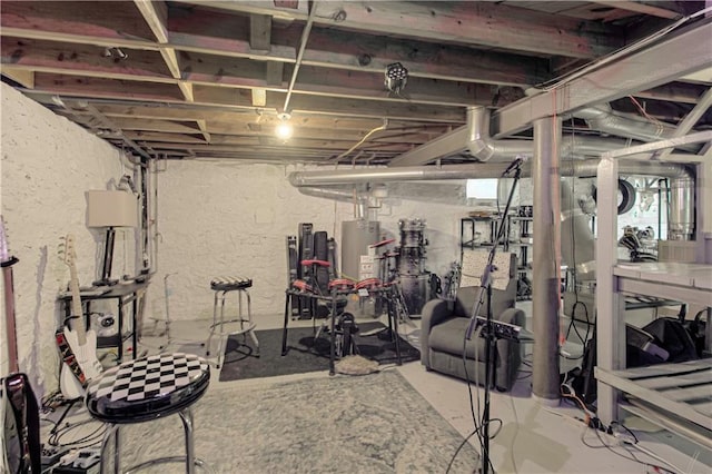 exercise area featuring concrete flooring and gas water heater