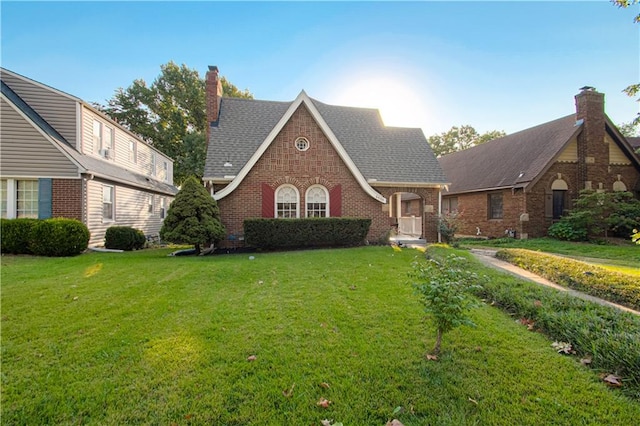 tudor-style house with a front yard