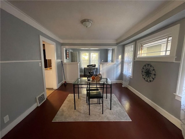 dining area with hardwood / wood-style flooring and ornamental molding