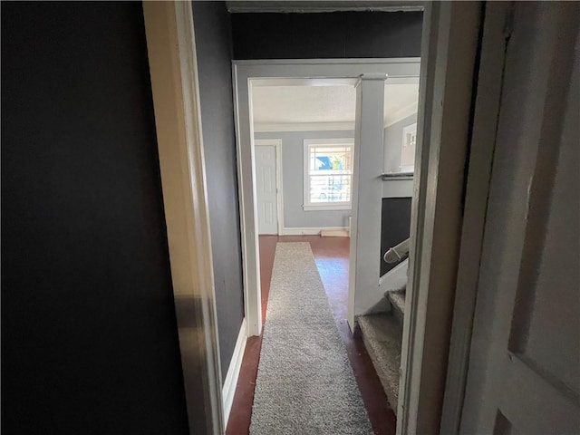 corridor with dark carpet and ornamental molding