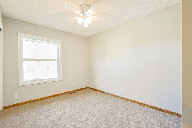 unfurnished room with carpet floors, a textured ceiling, and ceiling fan