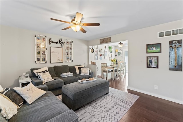 living room with wood-type flooring and ceiling fan