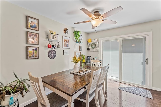 dining space with hardwood / wood-style flooring and ceiling fan