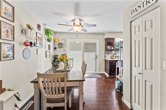 dining space featuring ceiling fan and dark hardwood / wood-style floors