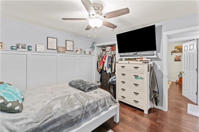 bedroom with a closet, dark hardwood / wood-style floors, and ceiling fan