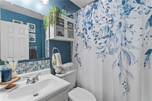 bathroom with vanity, toilet, and curtained shower