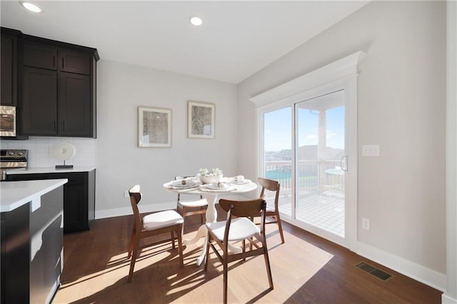 dining space featuring dark wood-type flooring