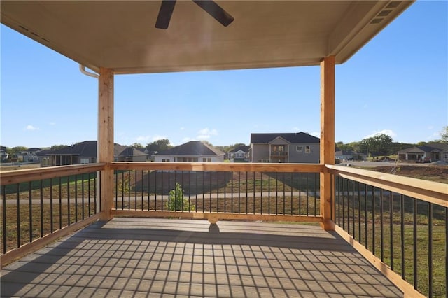 deck featuring ceiling fan and a lawn