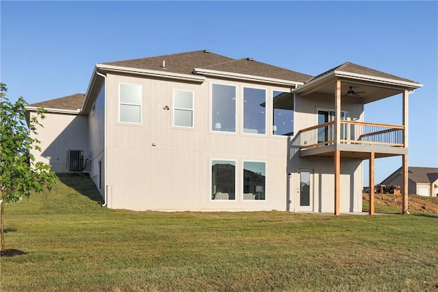 back of house featuring cooling unit, a balcony, a lawn, and ceiling fan