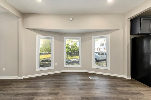 unfurnished dining area with dark hardwood / wood-style floors