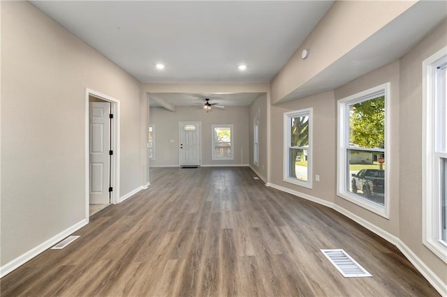 interior space featuring ceiling fan, a healthy amount of sunlight, and dark hardwood / wood-style floors