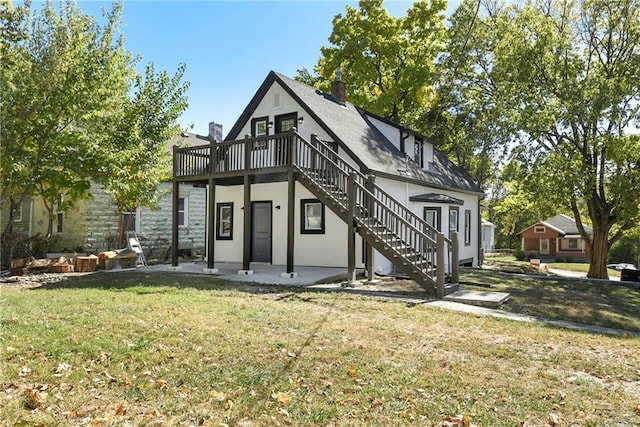 rear view of house featuring a yard