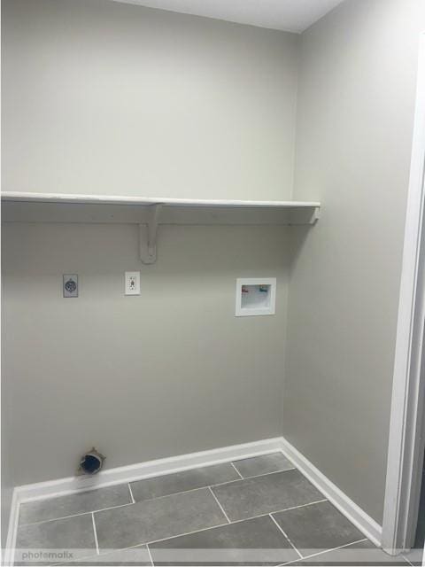 washroom featuring dark tile patterned floors, washer hookup, and hookup for an electric dryer