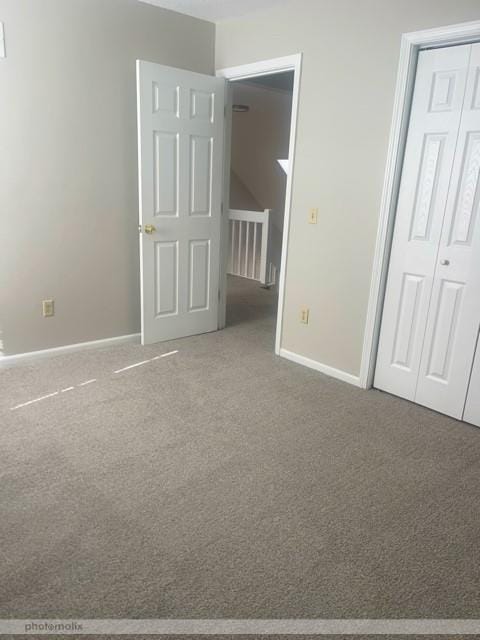 unfurnished bedroom with carpet flooring and a closet