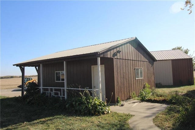 view of side of property featuring metal roof