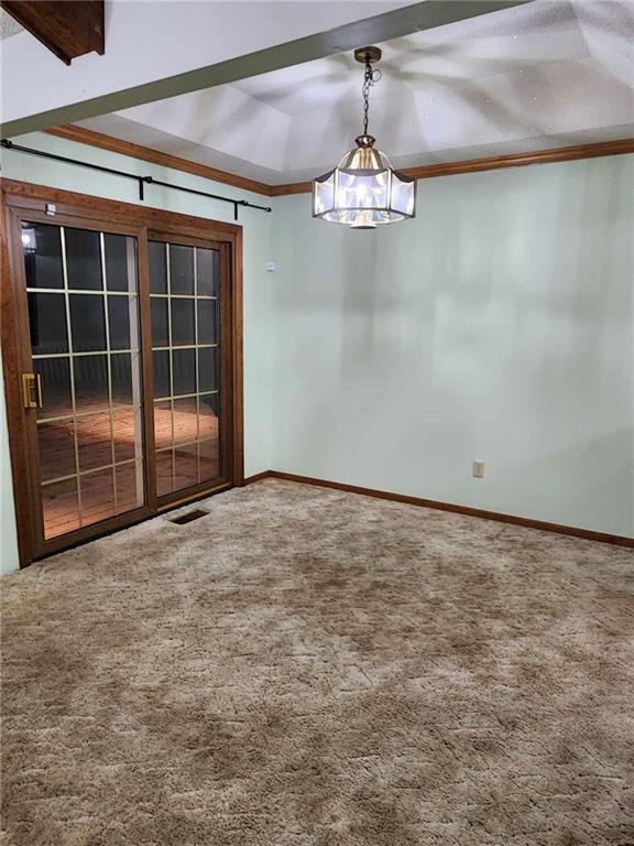 unfurnished room featuring carpet floors, visible vents, and baseboards