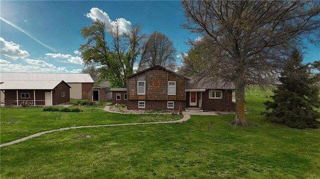 back of property featuring a yard