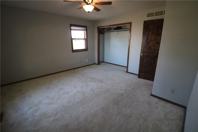 unfurnished bedroom featuring light carpet, baseboards, visible vents, a ceiling fan, and a closet