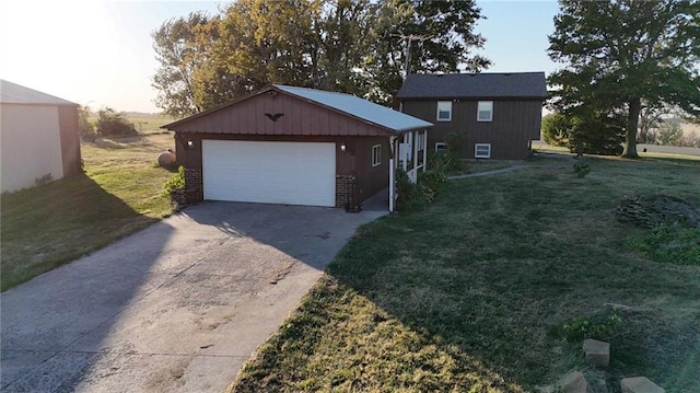 view of side of property featuring a lawn, an outdoor structure, and a garage