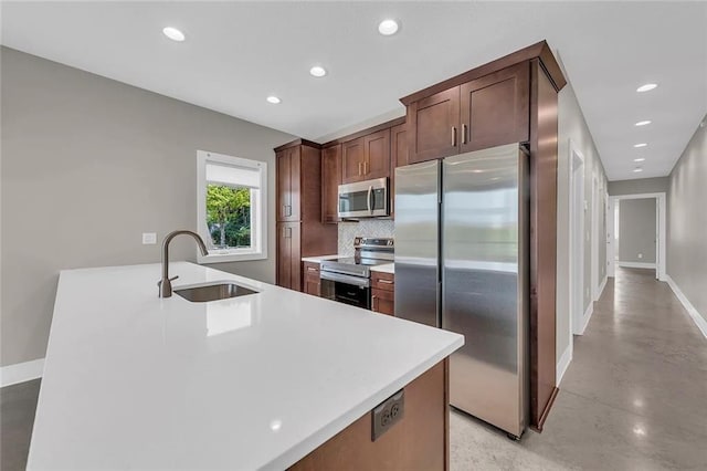 kitchen featuring appliances with stainless steel finishes, sink, and tasteful backsplash