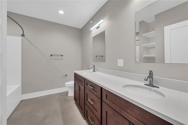 full bathroom with concrete flooring, washtub / shower combination, vanity, and toilet