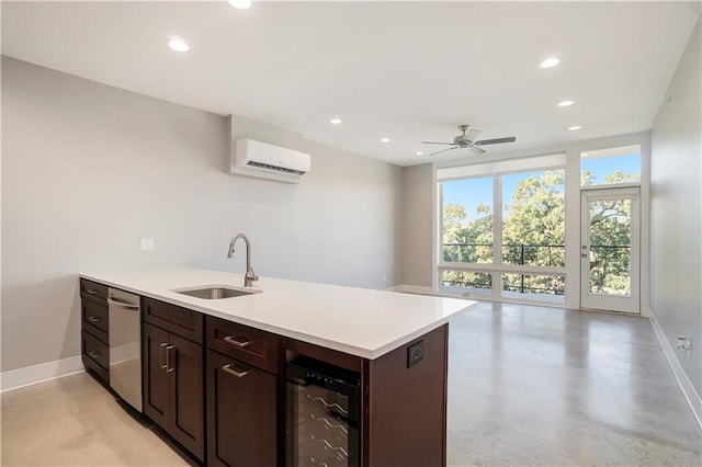 kitchen featuring an AC wall unit, dark brown cabinets, sink, beverage cooler, and ceiling fan