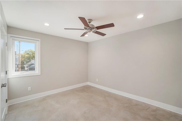 unfurnished room featuring light carpet and ceiling fan