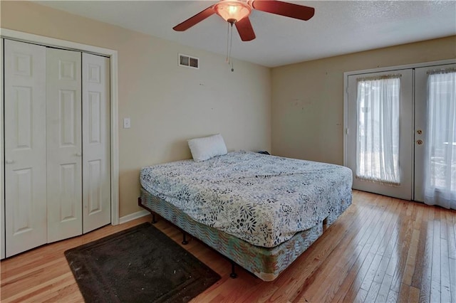 bedroom with french doors, wood-type flooring, and ceiling fan