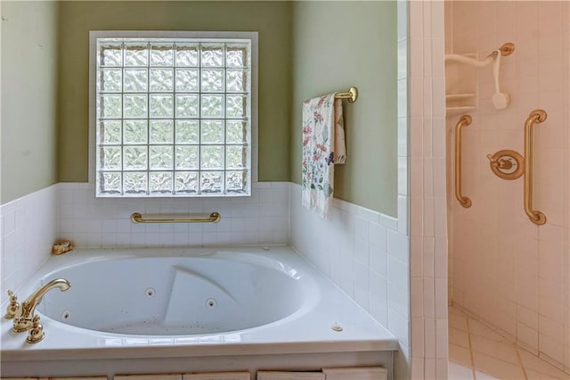 bathroom featuring a healthy amount of sunlight and separate shower and tub