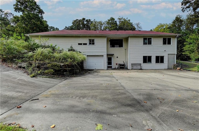 back of house with a garage