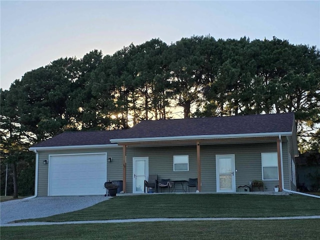 view of front of home featuring a yard and a garage