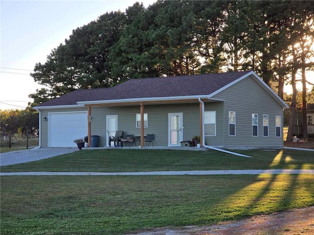 ranch-style house featuring a front yard and a garage