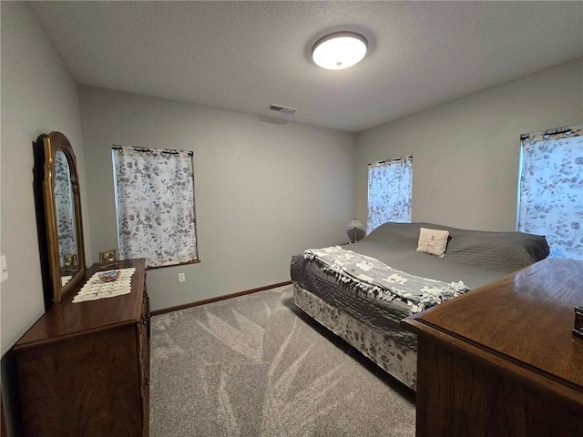 carpeted bedroom featuring a textured ceiling