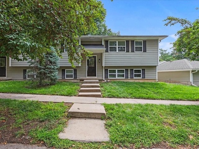 split foyer home with a front lawn