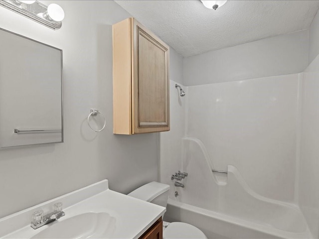 full bathroom with vanity, toilet, bathtub / shower combination, and a textured ceiling