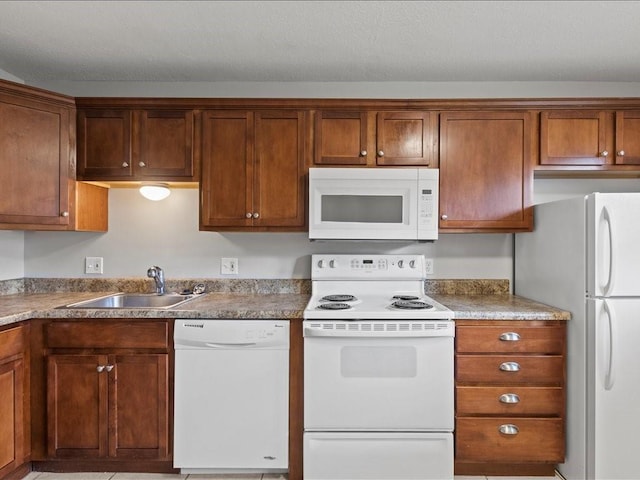 kitchen featuring sink and white appliances