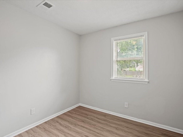 empty room with hardwood / wood-style flooring