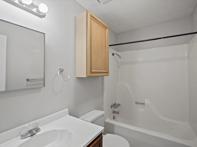 full bathroom featuring vanity, bathing tub / shower combination, and toilet