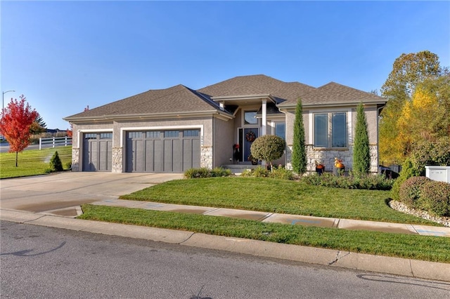 view of front facade with a front yard and a garage