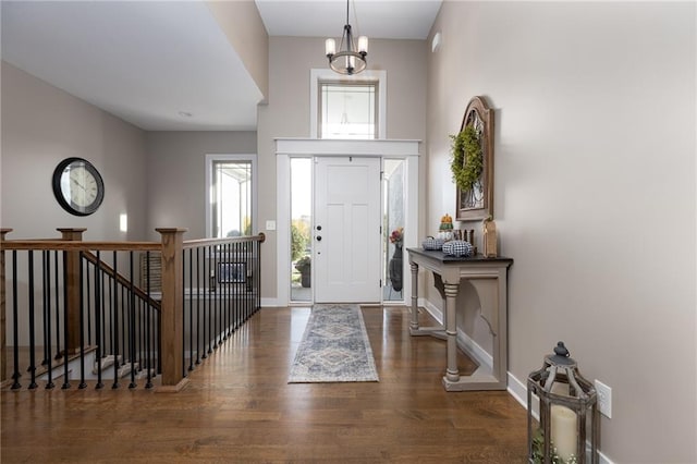 foyer with a chandelier and dark hardwood / wood-style floors