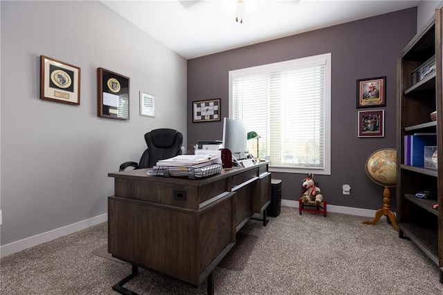 carpeted office space with ceiling fan