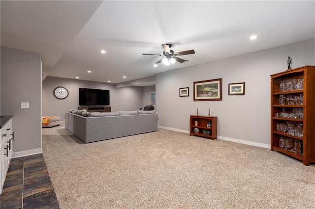 carpeted living room featuring ceiling fan