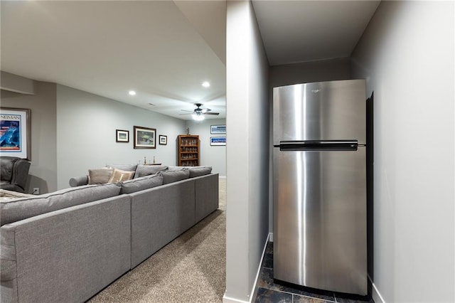 living room featuring dark carpet and ceiling fan